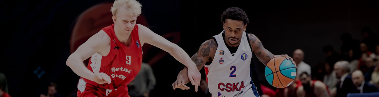 На изображении два баскетболиста, играющие на площадке. Один в белой форме с синей и красной полосками, другой в красной форме с номером 9. Игрок в белом ведет мяч. Фон размытый, с другими участниками игры